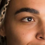 Close up of well groomed eyebrow and natural lashes showcasing lash and brow beauty at a Dallas studio