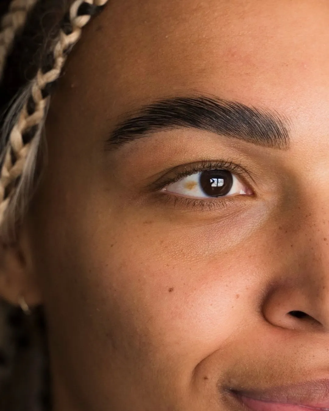 Close up of well groomed eyebrow and natural lashes showcasing lash and brow beauty at a Dallas studio