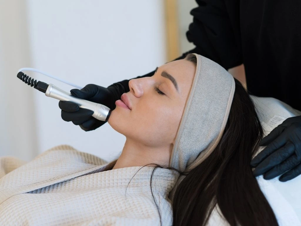 Woman receiving a microdermabrasion facial treatment at a Dallas skincare spa