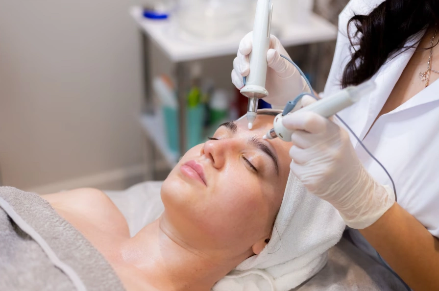 Client receiving a Hydrafacial Dallas treatment with dual skincare handpieces at Glow Up Studio