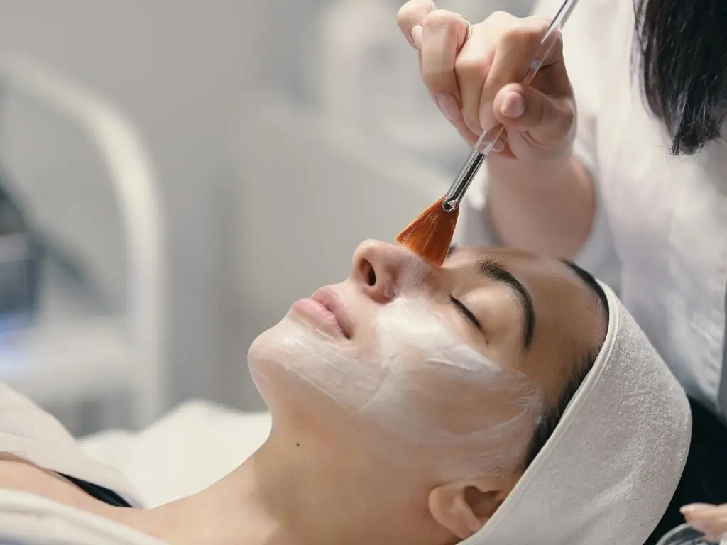 Woman receiving facial treatment