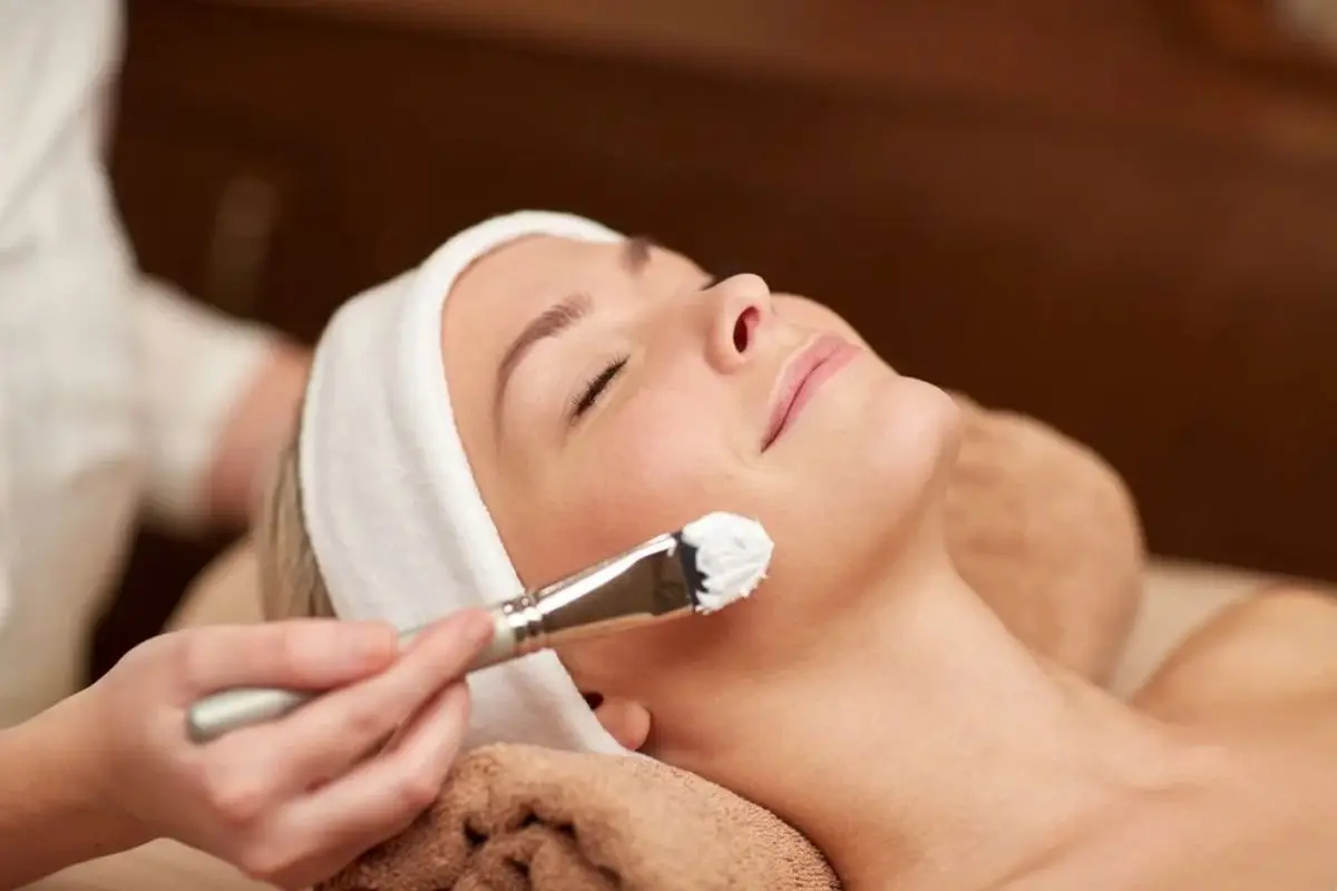 Woman receiving a facial treatment.